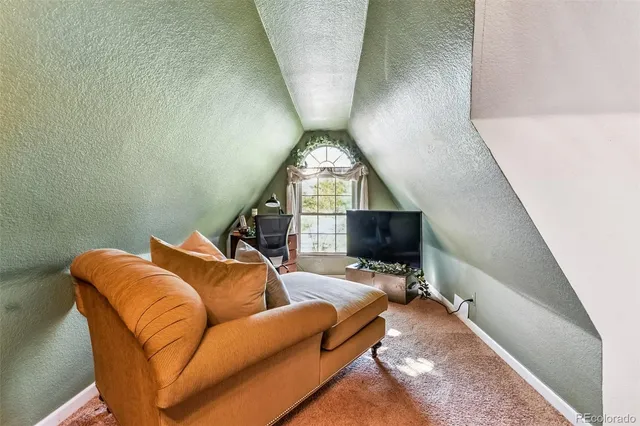 a living room with furniture a fireplace and a flat tv screen