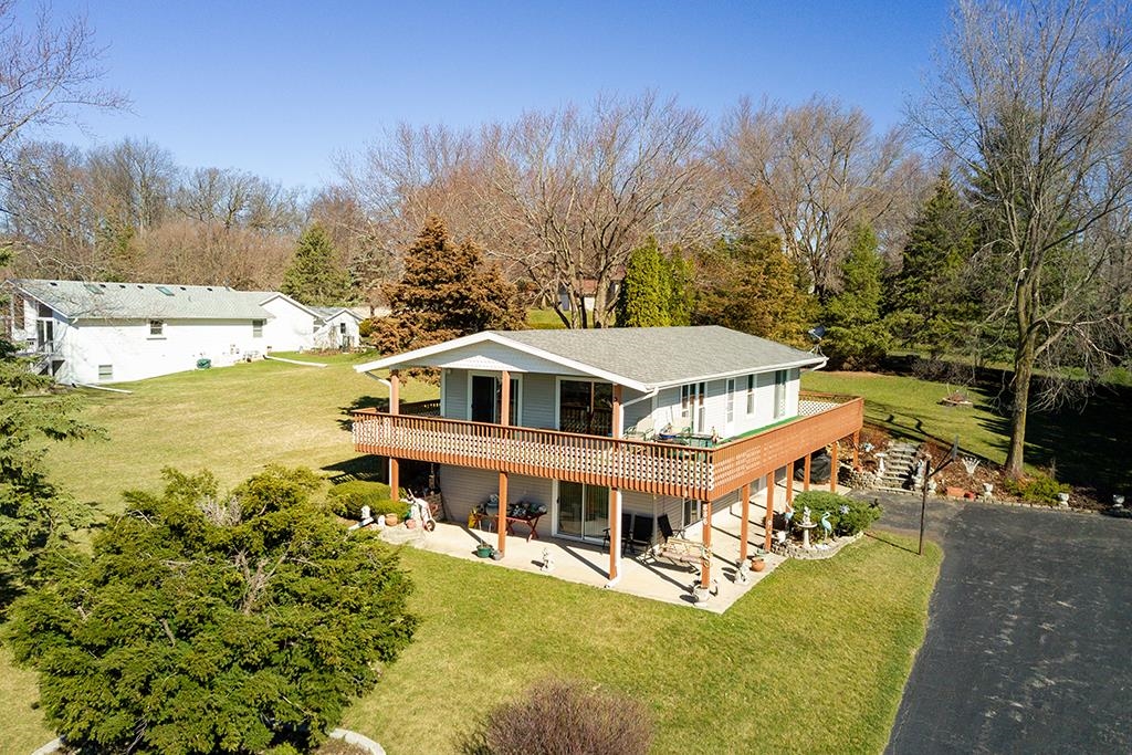 886 Breckenboro Road Davis, IL 61019 - Photo 1 of 37 a view of a white house with a big yard and large trees