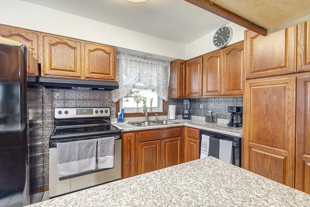 886 Breckenboro Road Davis, IL 61019 - Photo 17 of 37 a kitchen with stainless steel appliances granite countertop a stove sink and cabinets