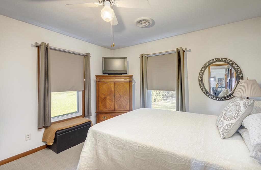 886 Breckenboro Road Davis, IL 61019 - Photo 25 of 37 a bedroom with a bed a dresser and flat screen tv