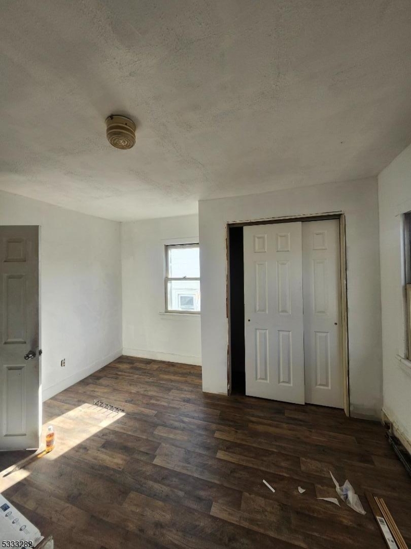 20 Adams Street Belvidere, NJ 07823 - Photo 2 of 11 an empty room with wooden floor and windows
