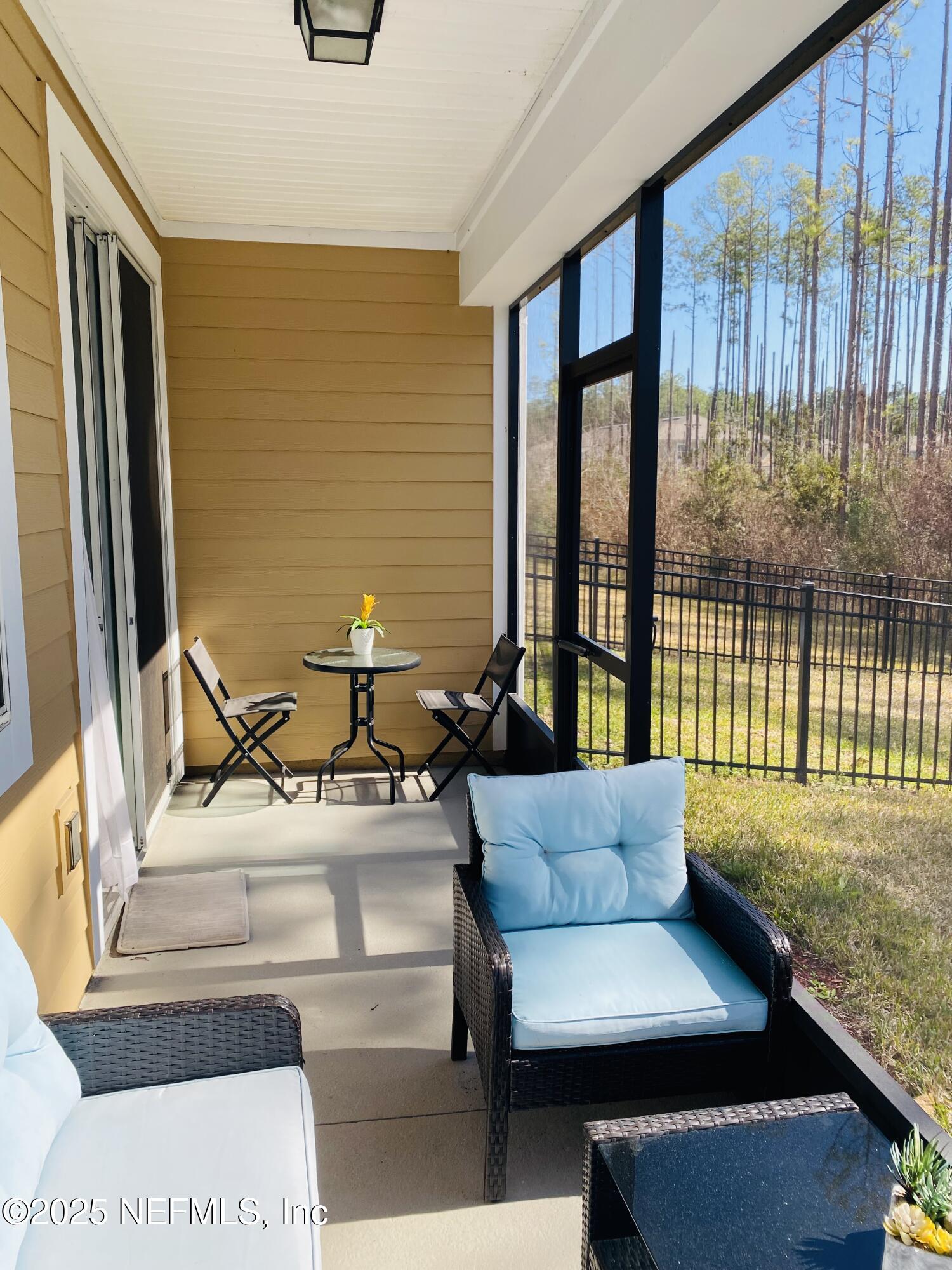 99 Bush Place St. Johns, FL 32259 - Photo 12 of 21 a living room with furniture and a floor to ceiling window