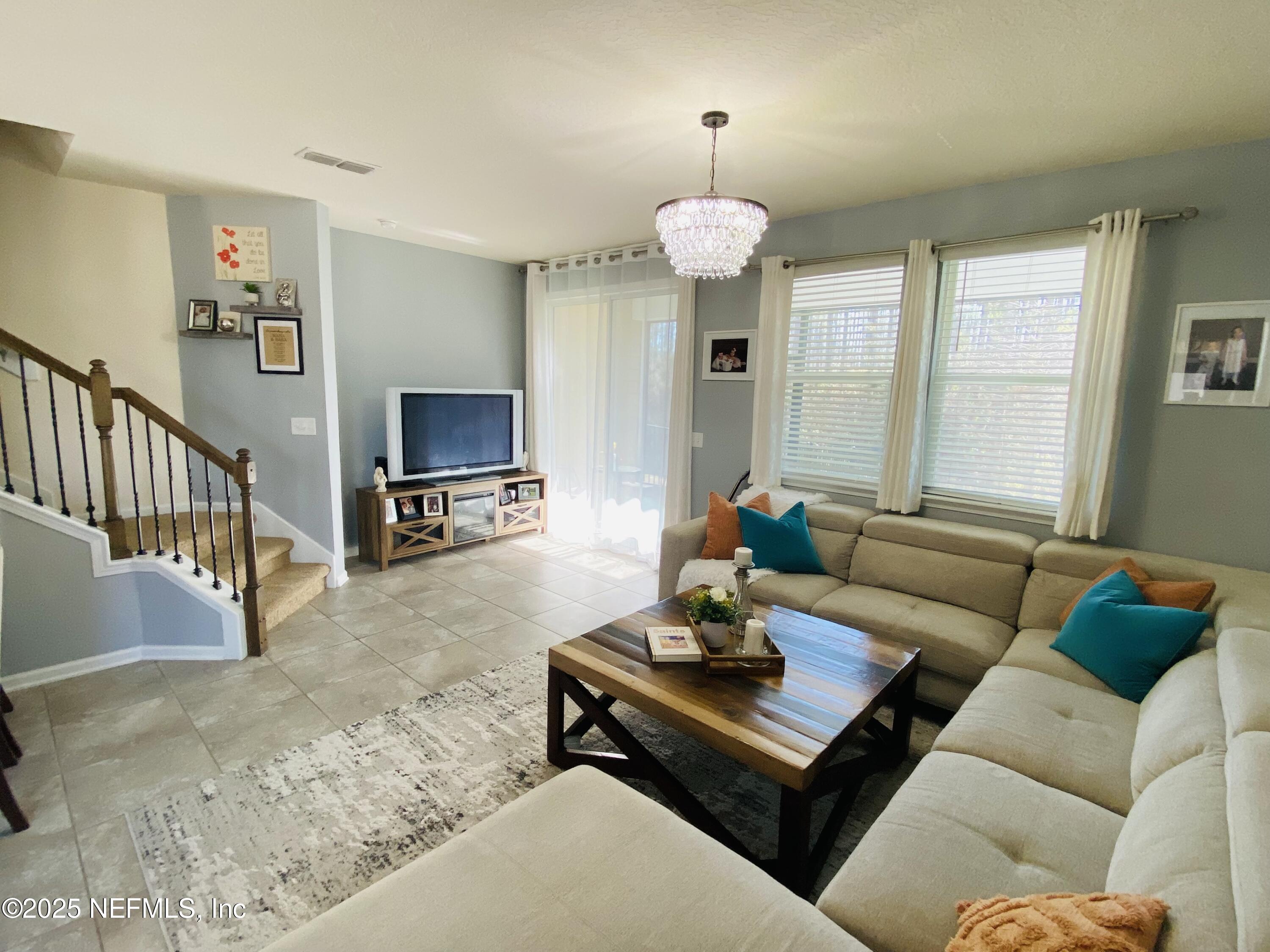 99 Bush Place St. Johns, FL 32259 - Photo 6 of 21 a living room with furniture a flat screen tv and a large window