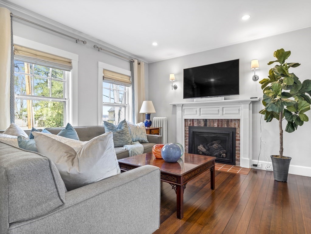 97 Crest Road Wellesley, MA 02482 - Photo 3 of 26 a living room with furniture a flat screen tv and a fireplace