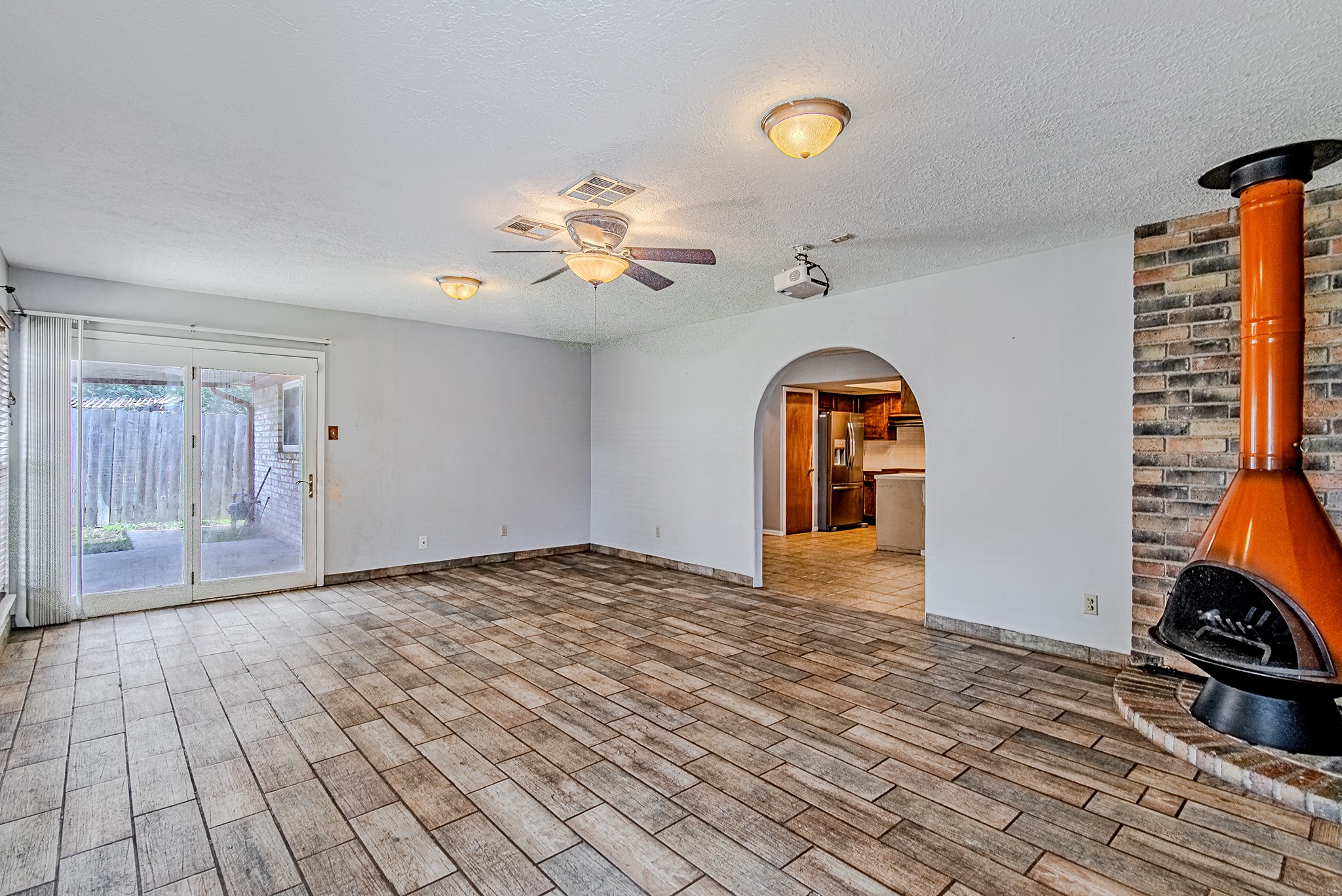 2710 Burke Road Pasadena, TX 77502 - Photo 13 of 28 Spacious living area featuring a charming fireplace focal point