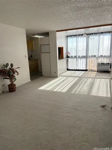 a view of a livingroom with a furniture and floor to ceiling window