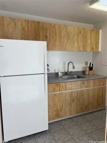 a kitchen with a sink and a refrigerator