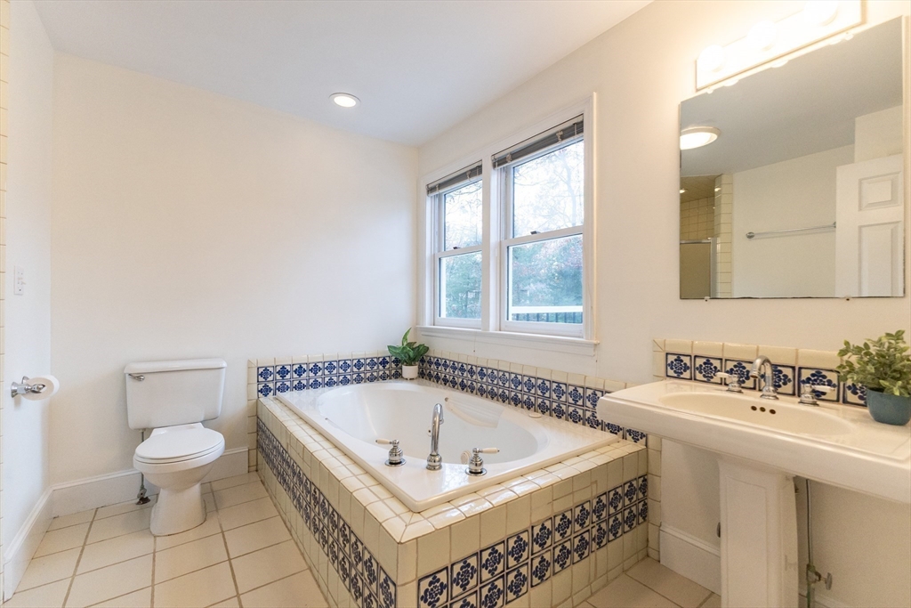 5 Old Wood Road North Attleboro, MA 02760 - Photo 25 of 41 a bathroom with a bathtub a sink a toilet and a window