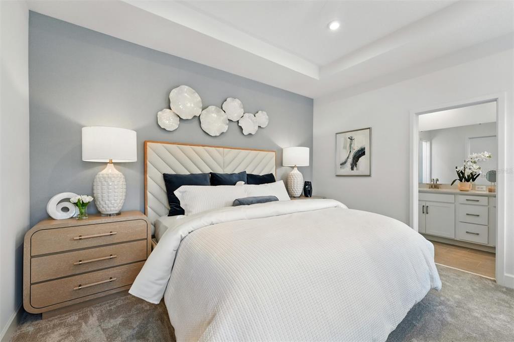 1792 Headland Loop Celebration, FL 34747 - Photo 12 of 31 a bedroom with a bed and a chandelier
