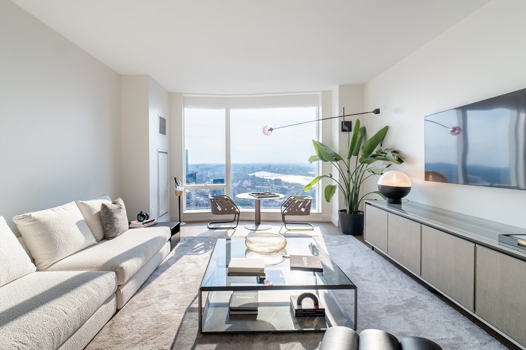 240 Devonshire Street, Unit U5404 Boston, MA 02110 - Photo 3 of 40 a living room with furniture and a large window