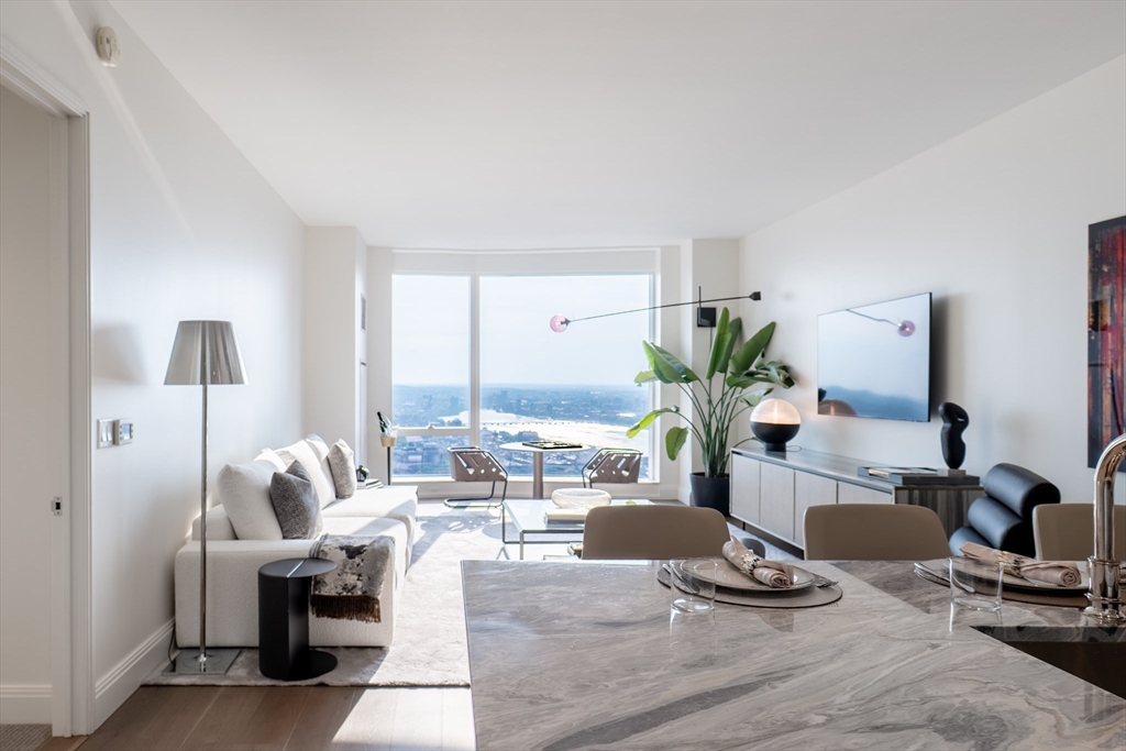 240 Devonshire Street, Unit U5404 Boston, MA 02110 - Photo 4 of 40 a living room with furniture hard wood floor and view of kitchen