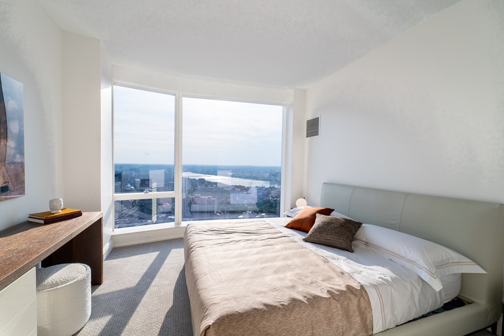 240 Devonshire Street, Unit U5404 Boston, MA 02110 - Photo 9 of 40 a bed sitting in a bedroom next to a window