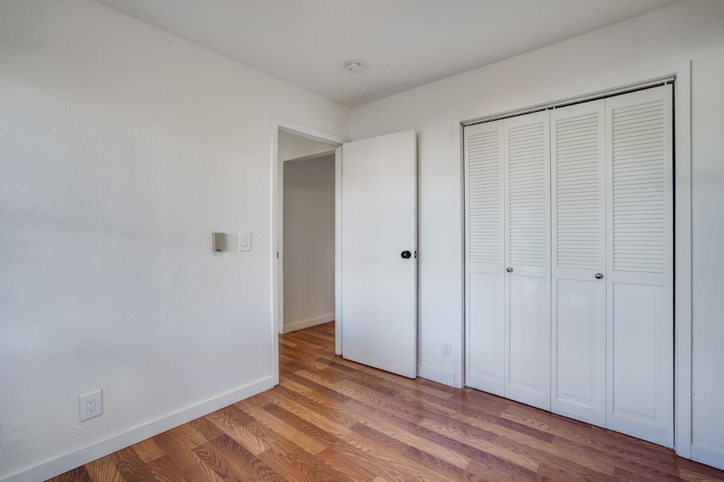 1218 Middlefield Road Palo Alto, CA 94301 - Photo 12 of 31 a view of an empty room with wooden floor