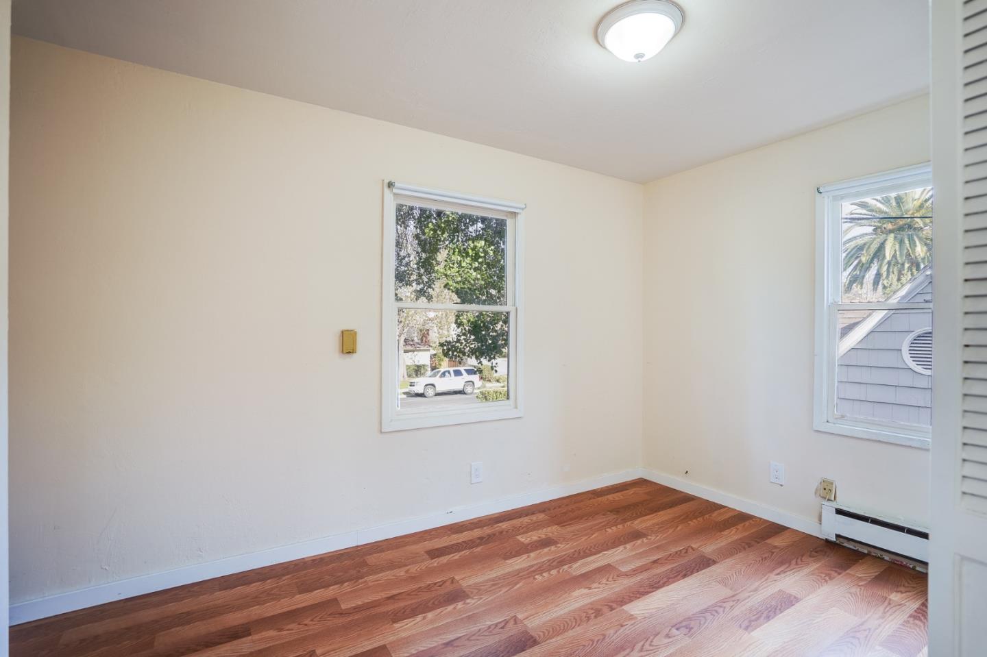1218 Middlefield Road Palo Alto, CA 94301 - Photo 15 of 31 an empty room with wooden floor and windows