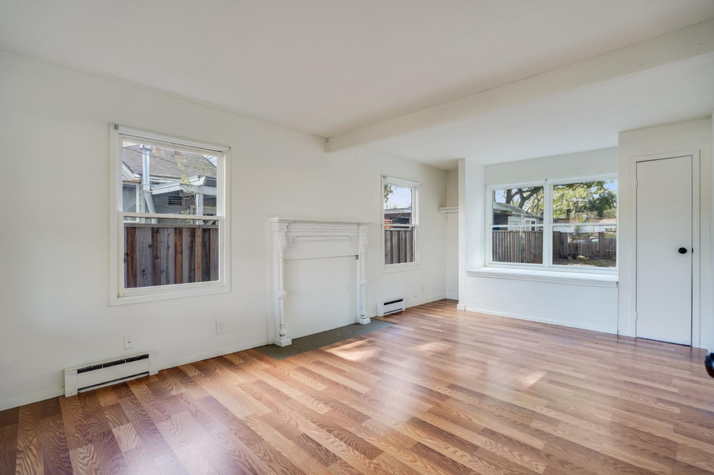 1218 Middlefield Road Palo Alto, CA 94301 - Photo 4 of 31 a view of an empty room with window and wooden floor
