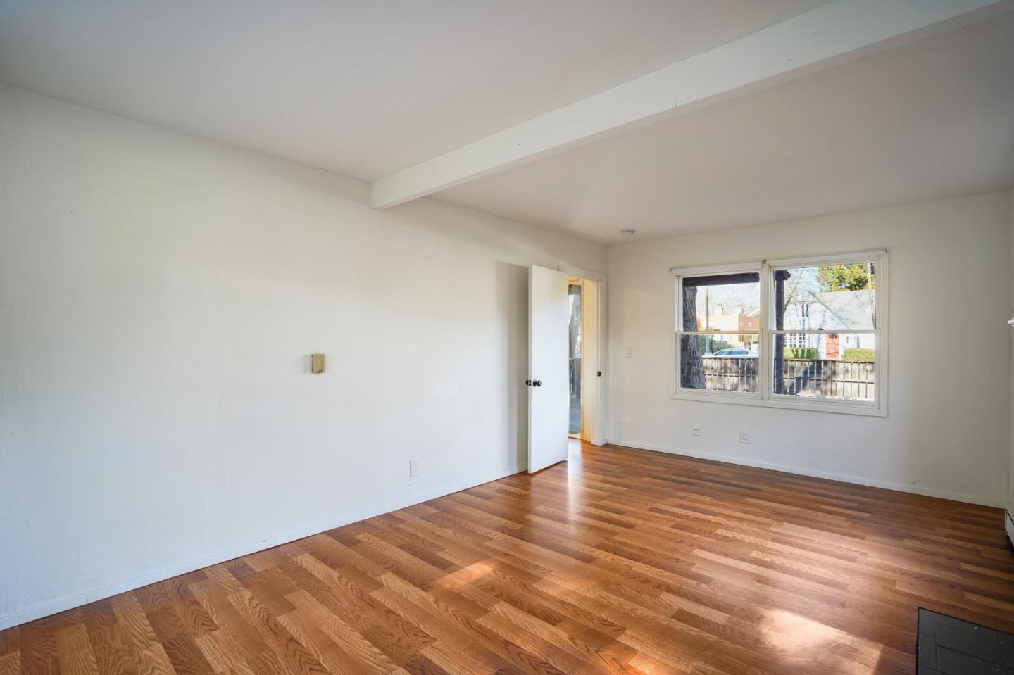 1218 Middlefield Road Palo Alto, CA 94301 - Photo 5 of 31 a view of an empty room with wooden floor and a window