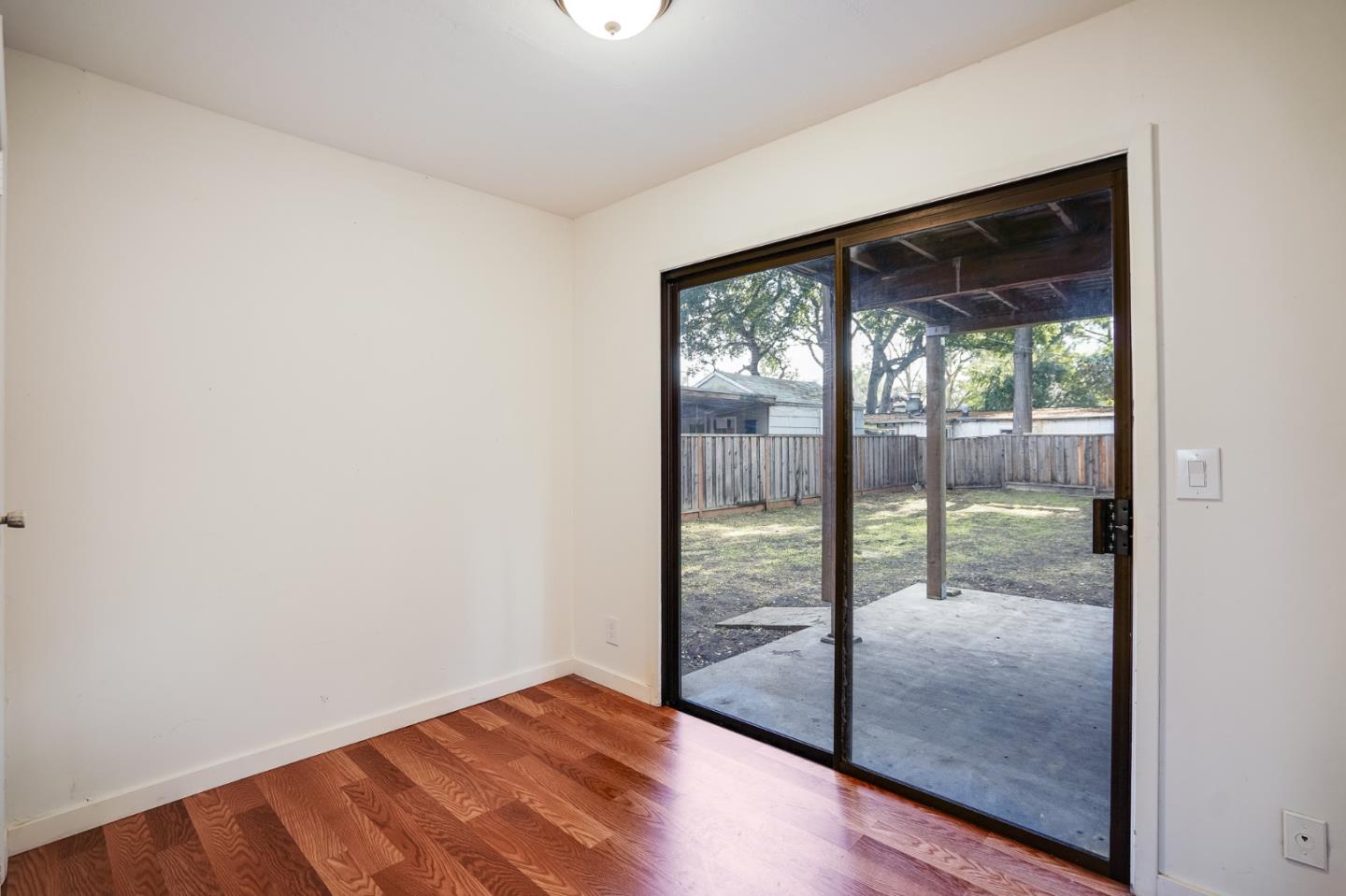 1218 Middlefield Road Palo Alto, CA 94301 - Photo 8 of 31 a view of empty room with wooden floor and floor to ceiling window