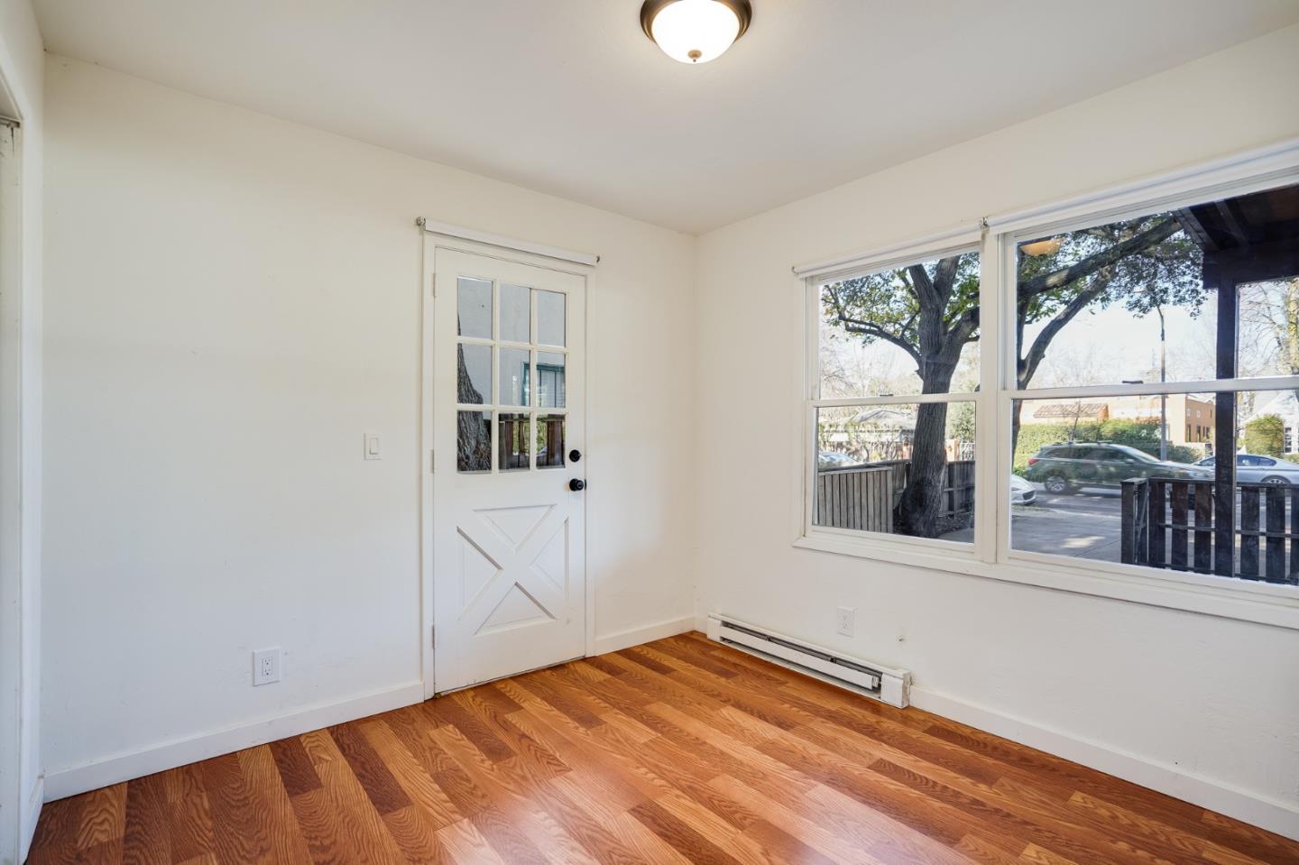 1218 Middlefield Road Palo Alto, CA 94301 - Photo 9 of 31 a view of an empty room with a window and wooden floor