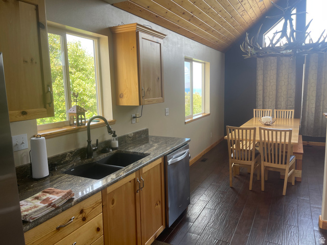 553 Raspberry Patch Road Garden City, UT 84028 - Photo 13 of 21 Kitchen featuring a vaulted wooden ceiling, stainless steel appliances, dark wood-type flooring, and dark stone counters