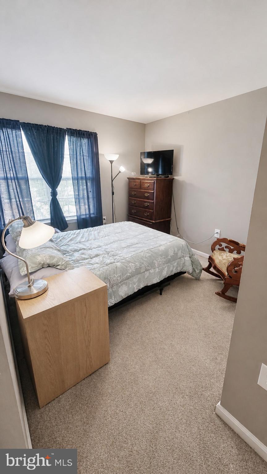15370 Inlet Place Dumfries, VA 22025 - Photo 19 of 30 a bedroom with a bed and dresser