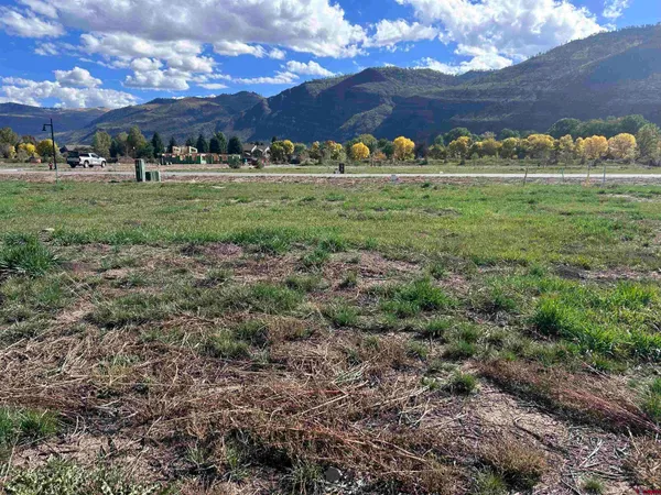 a view of a big yard with table and chairs