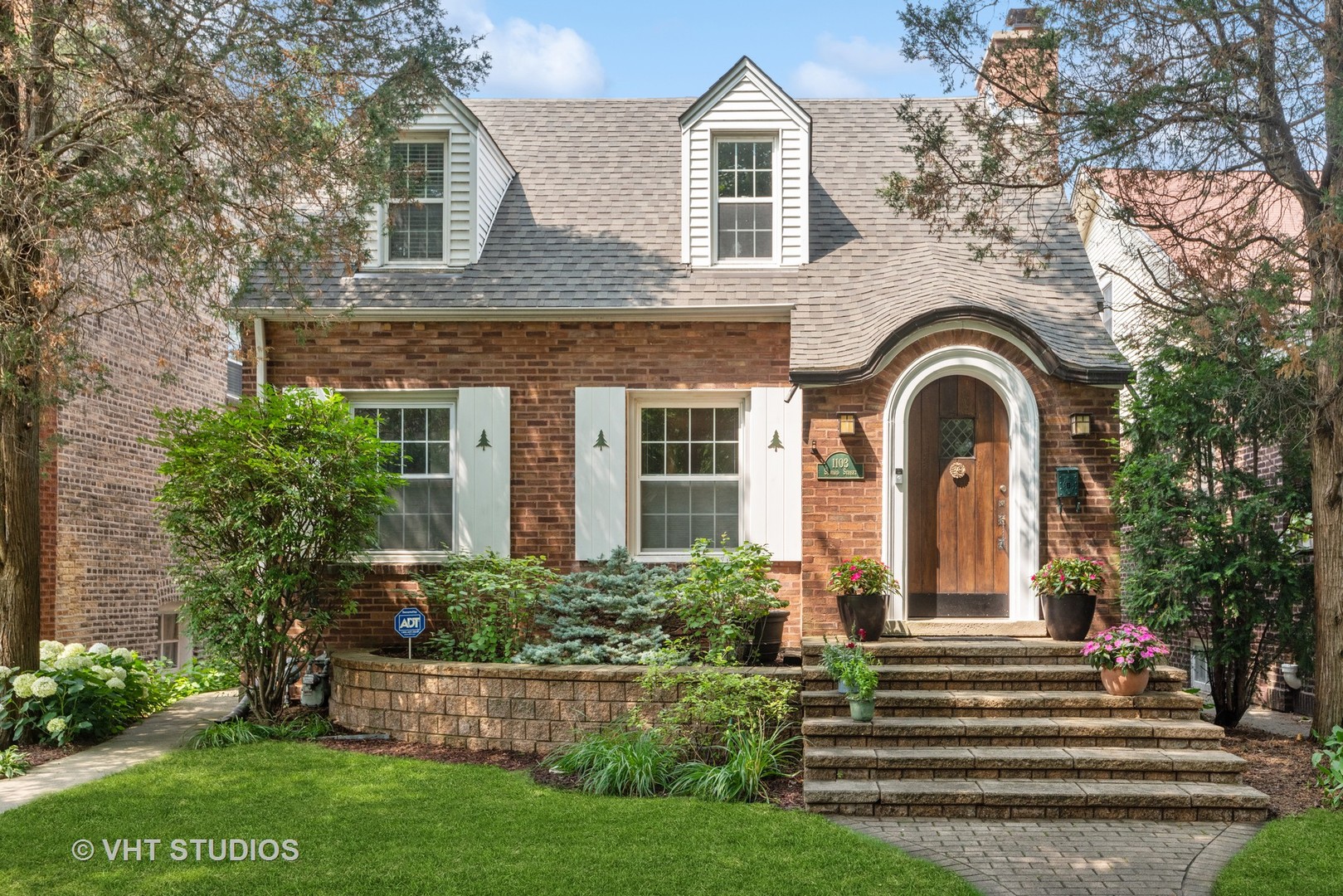a front view of a house with a garden