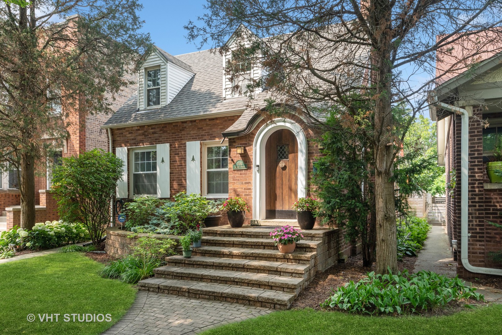 1103 Seward Street Evanston, IL 60202 - Photo 2 of 39 a front view of a house with a garden