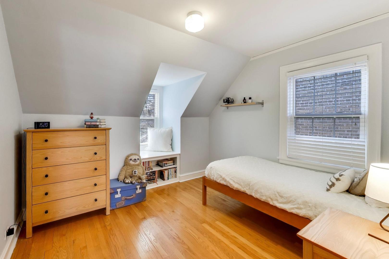 1103 Seward Street Evanston, IL 60202 - Photo 22 of 39 a bedroom with a bed and a dresser