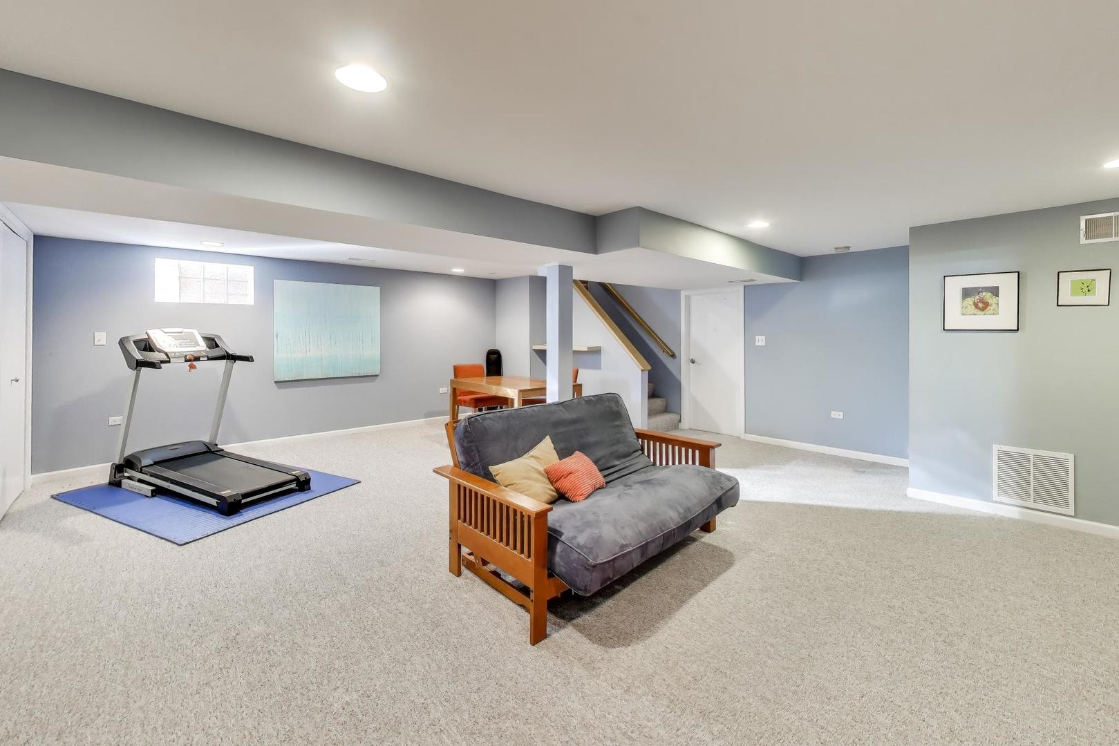 1103 Seward Street Evanston, IL 60202 - Photo 25 of 39 a living room with furniture and a wooden floor