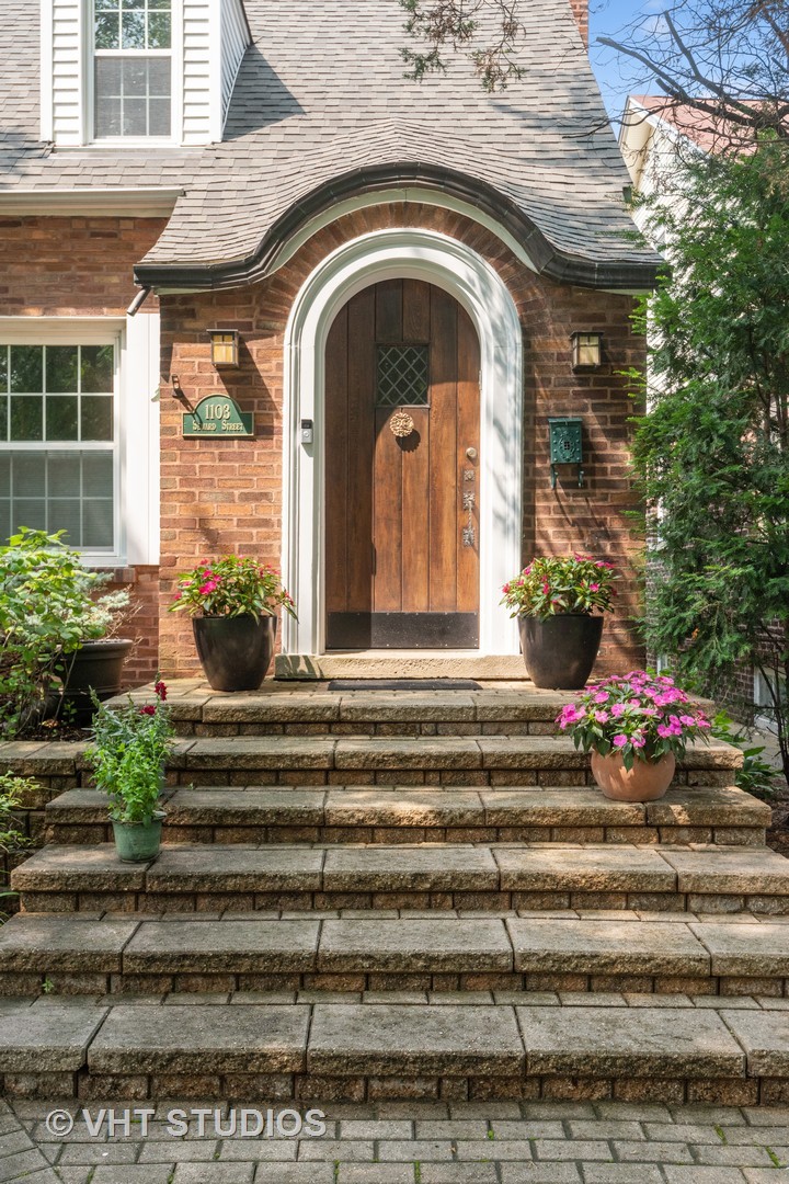 1103 Seward Street Evanston, IL 60202 - Photo 3 of 39 a front view of a house with a garden