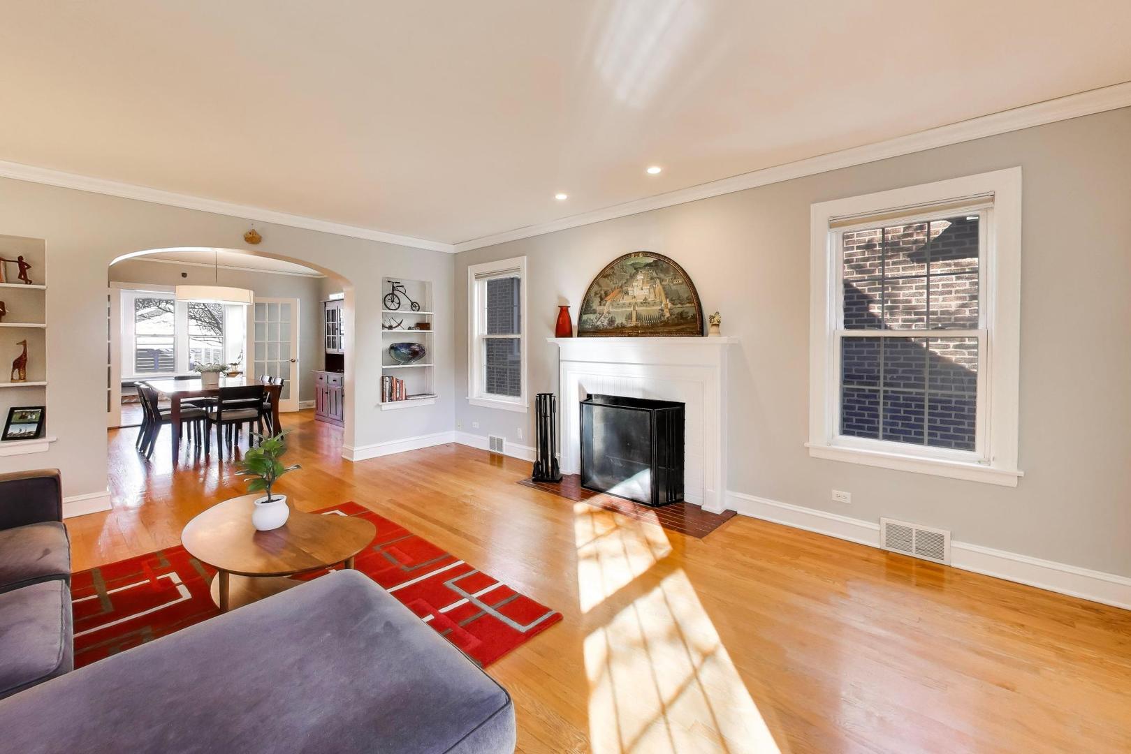 1103 Seward Street Evanston, IL 60202 - Photo 7 of 39 a living room with furniture a fireplace and a table