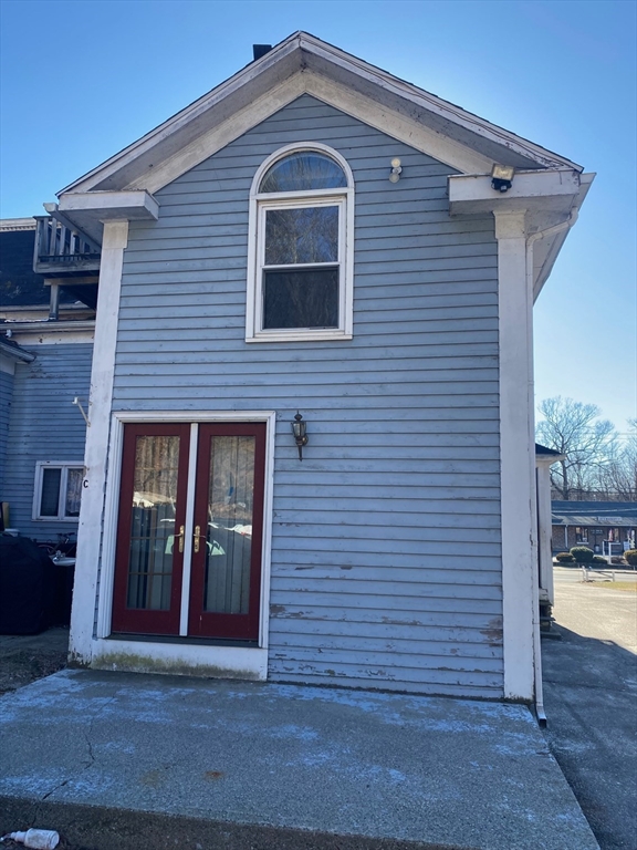 66 Main Street, Unit C Blackstone, MA 01504 - Photo 11 of 35 a front view of a house with a yard