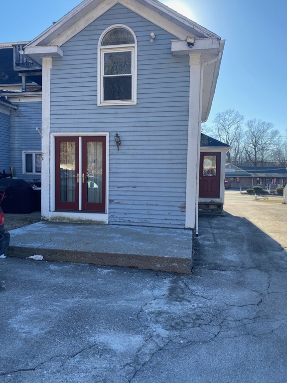 66 Main Street, Unit C Blackstone, MA 01504 - Photo 12 of 35 a view of front door of house with yard