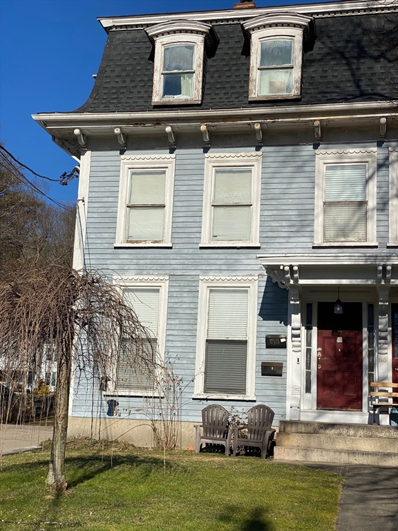 66 Main Street, Unit C Blackstone, MA 01504 - Photo 7 of 35 a front view of a house with lots of trees