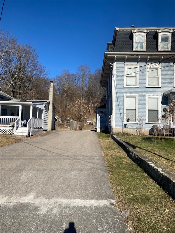 66 Main Street, Unit C Blackstone, MA 01504 - Photo 8 of 35 a front view of a house with a yard