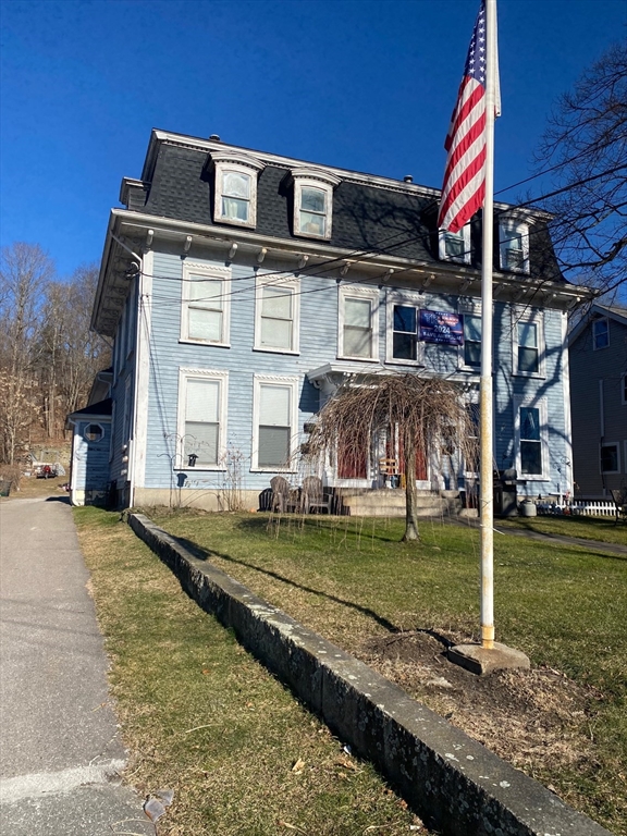 66 Main Street, Unit C Blackstone, MA 01504 - Photo 9 of 35 a front view of a house with a yard
