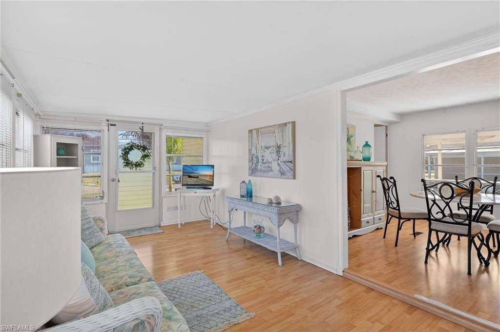 101 Rookery Road Naples, FL 34114 - Photo 13 of 43 a living room with furniture and a wooden floor