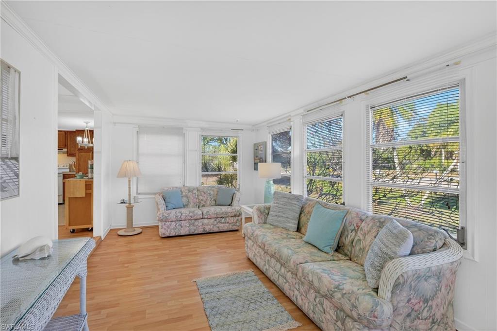 101 Rookery Road Naples, FL 34114 - Photo 14 of 43 a living room with furniture and a large window