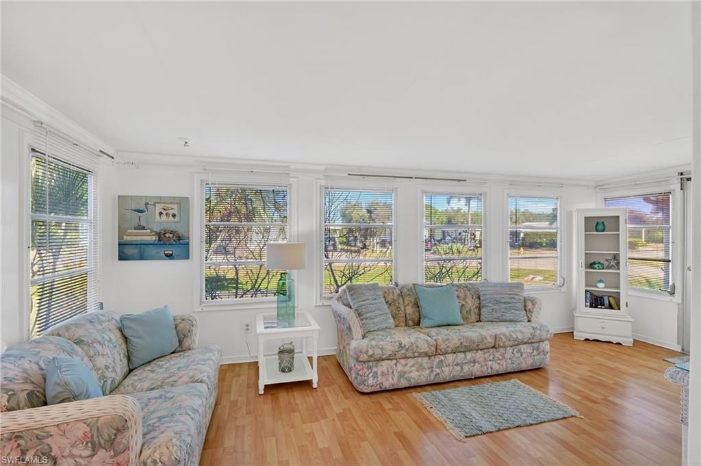 101 Rookery Road Naples, FL 34114 - Photo 15 of 43 a living room with furniture and a wooden floor