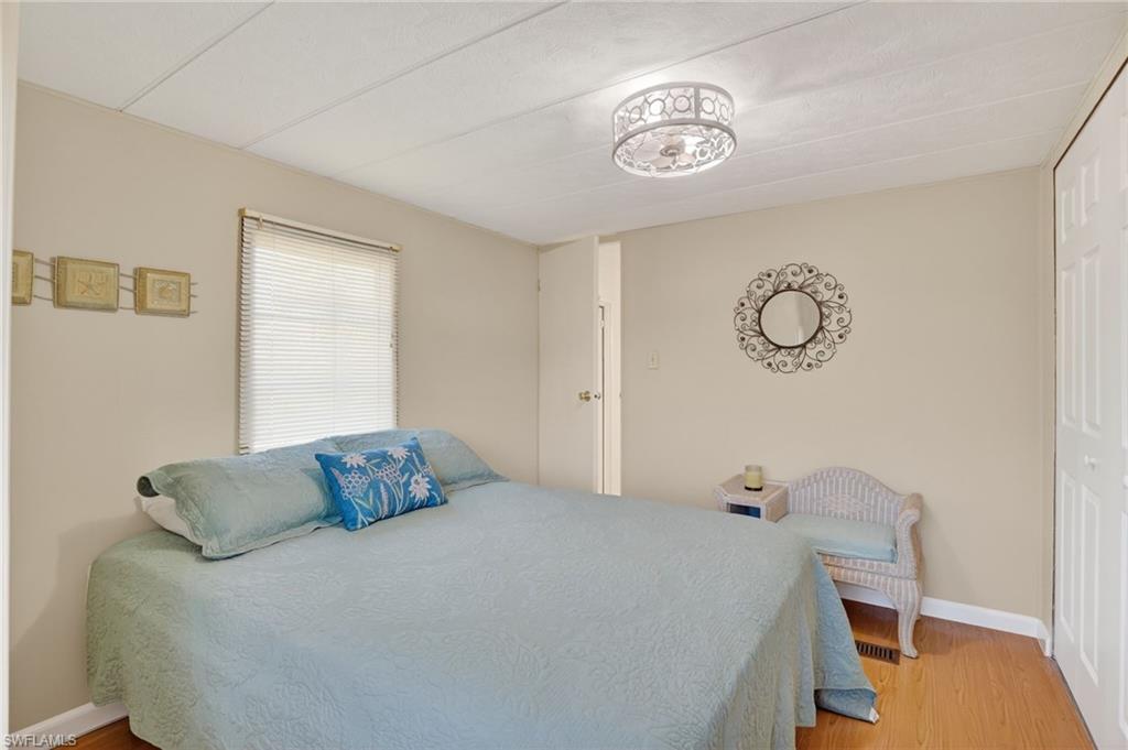 101 Rookery Road Naples, FL 34114 - Photo 18 of 43 a bedroom with a bed and a chandelier