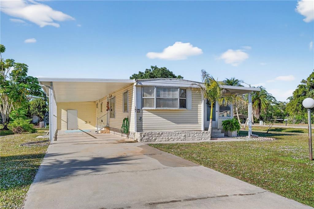101 Rookery Road Naples, FL 34114 - Photo 2 of 43 a front view of a house with a yard