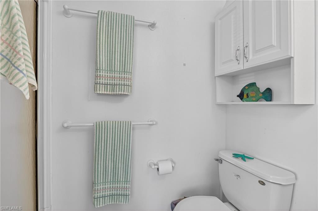 101 Rookery Road Naples, FL 34114 - Photo 22 of 43 a bathroom with a toilet a sink and a window