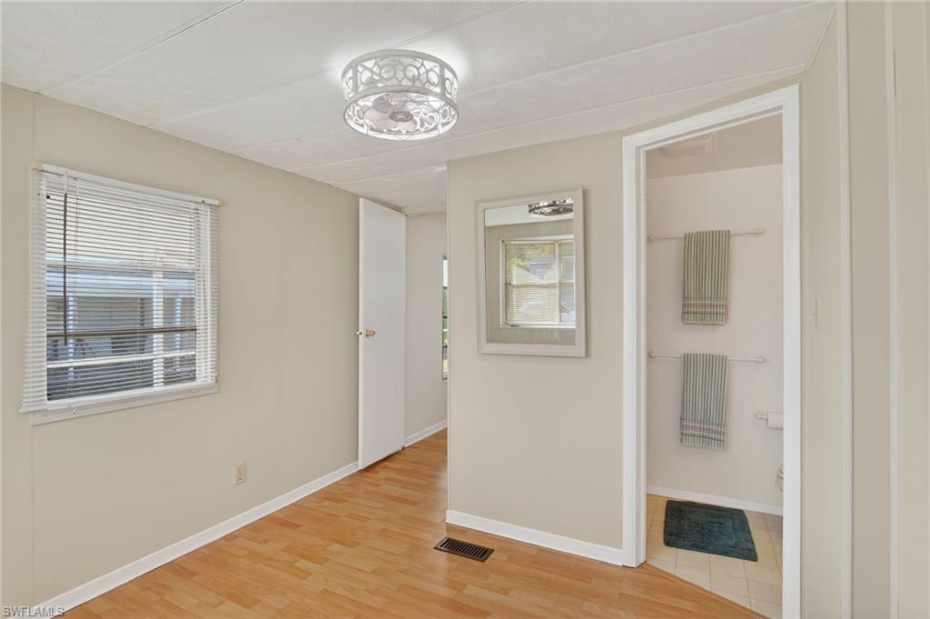 101 Rookery Road Naples, FL 34114 - Photo 24 of 43 a view of a livingroom with wooden floor and a window