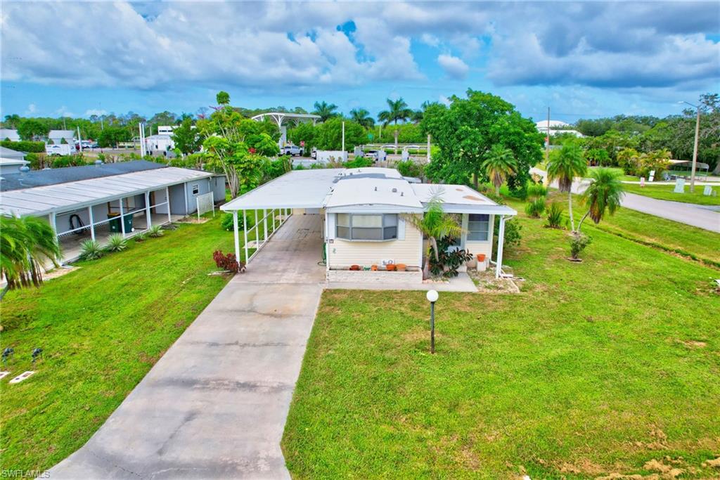 101 Rookery Road Naples, FL 34114 - Photo 28 of 43 a view of a patio with a table and chairs under an umbrella