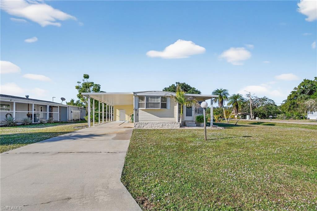 101 Rookery Road Naples, FL 34114 - Photo 3 of 43 a swimming pool with a yard and plants