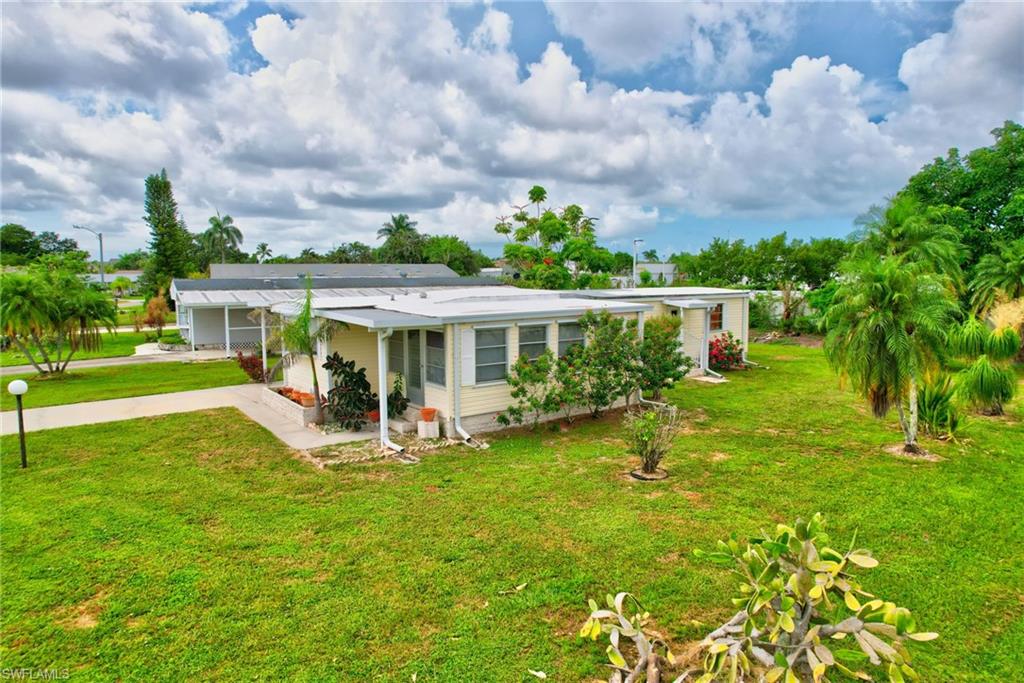 101 Rookery Road Naples, FL 34114 - Photo 33 of 43 a view of house with garden and trees