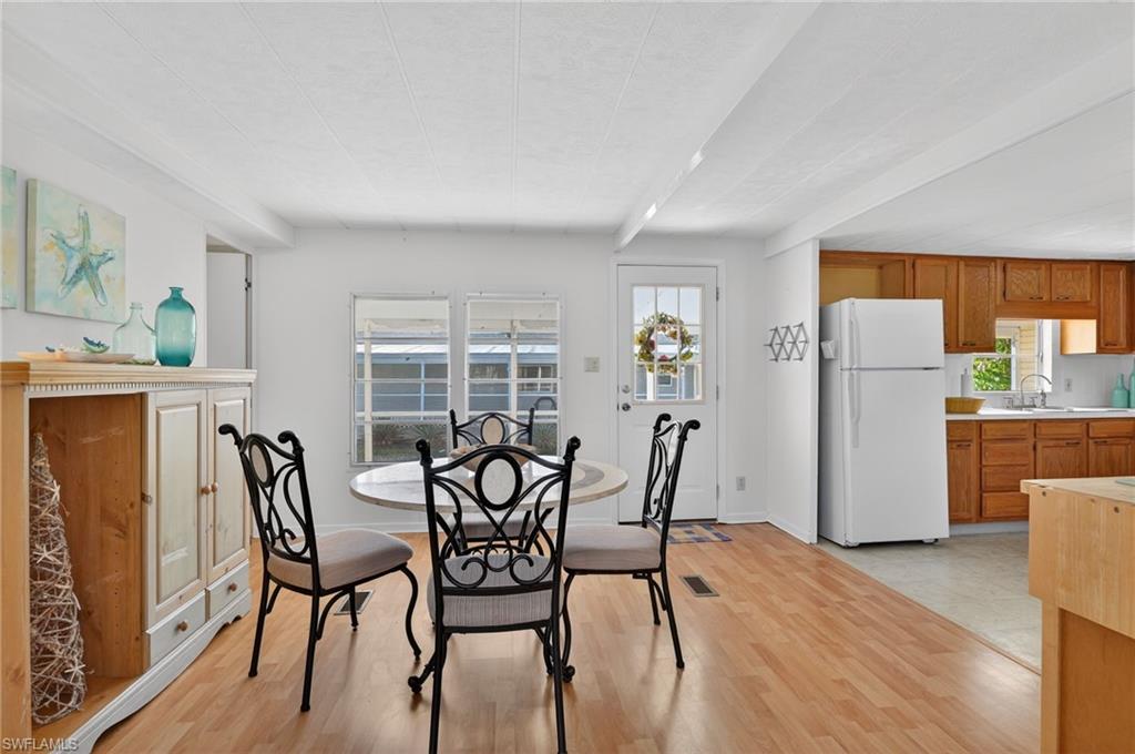 101 Rookery Road Naples, FL 34114 - Photo 4 of 43 a view of a dining room with furniture and wooden floor