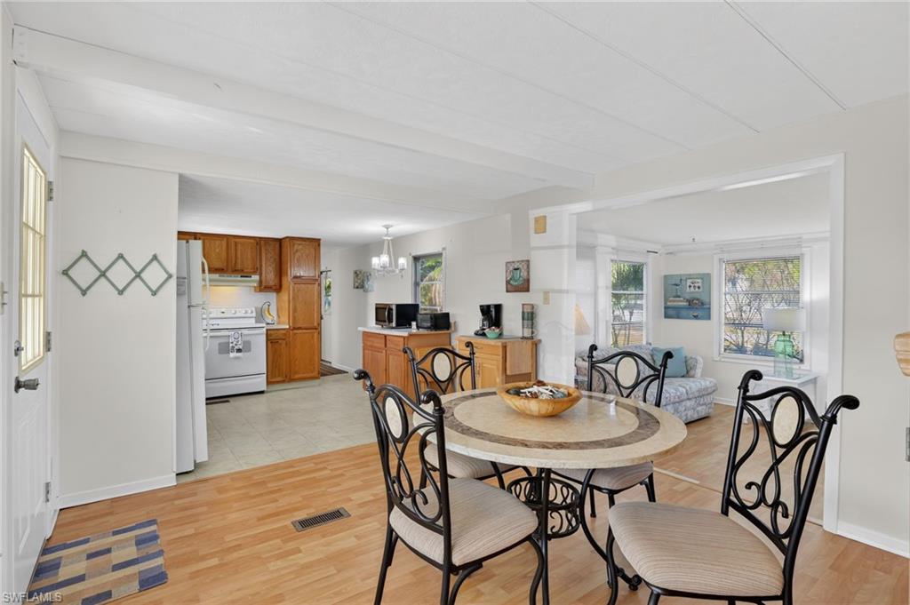 101 Rookery Road Naples, FL 34114 - Photo 6 of 43 a view of a dining room with furniture and wooden floor