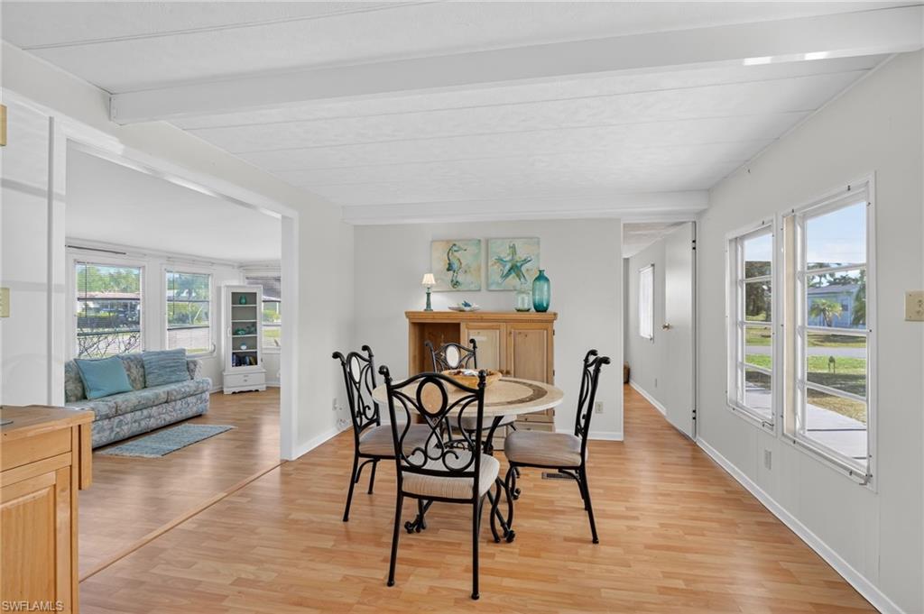 101 Rookery Road Naples, FL 34114 - Photo 7 of 43 a view of a dining room with furniture and wooden floor