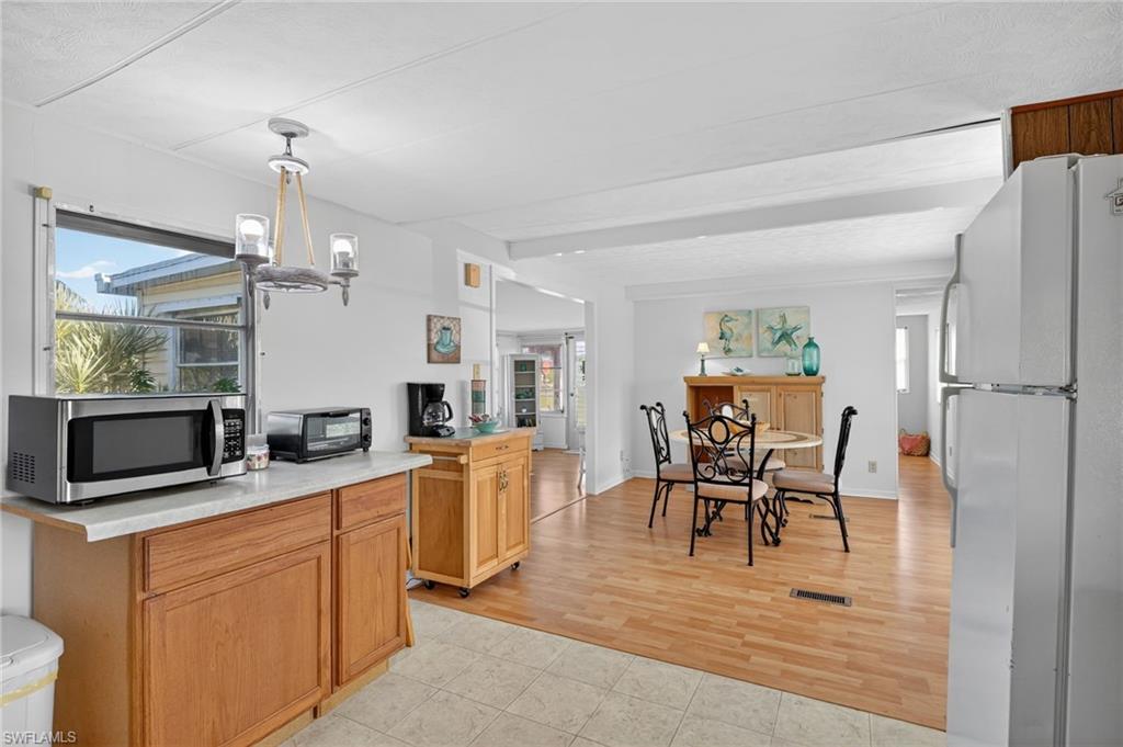 101 Rookery Road Naples, FL 34114 - Photo 9 of 43 a view of a dining room with furniture and wooden floor